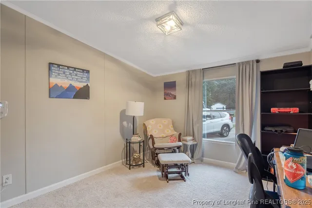 a view of a workspace with furniture and a bedroom