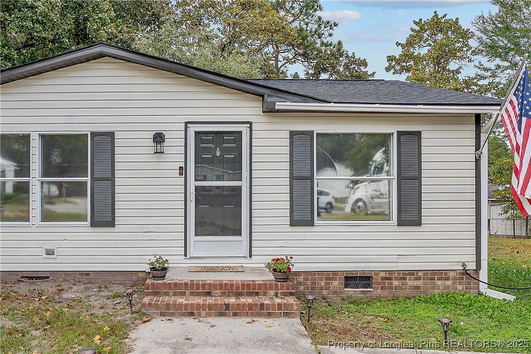 54 West Tryon Court Spring Lake, NC 28390 - Photo 3 of 43 a front view of a house with a yard