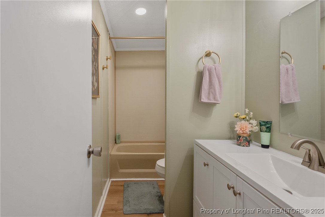 54 West Tryon Court Spring Lake, NC 28390 - Photo 32 of 43 a bathroom with a tub sink and mirror