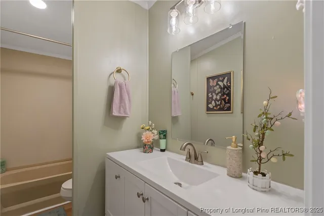 a bathroom with a sink vanity and mirror