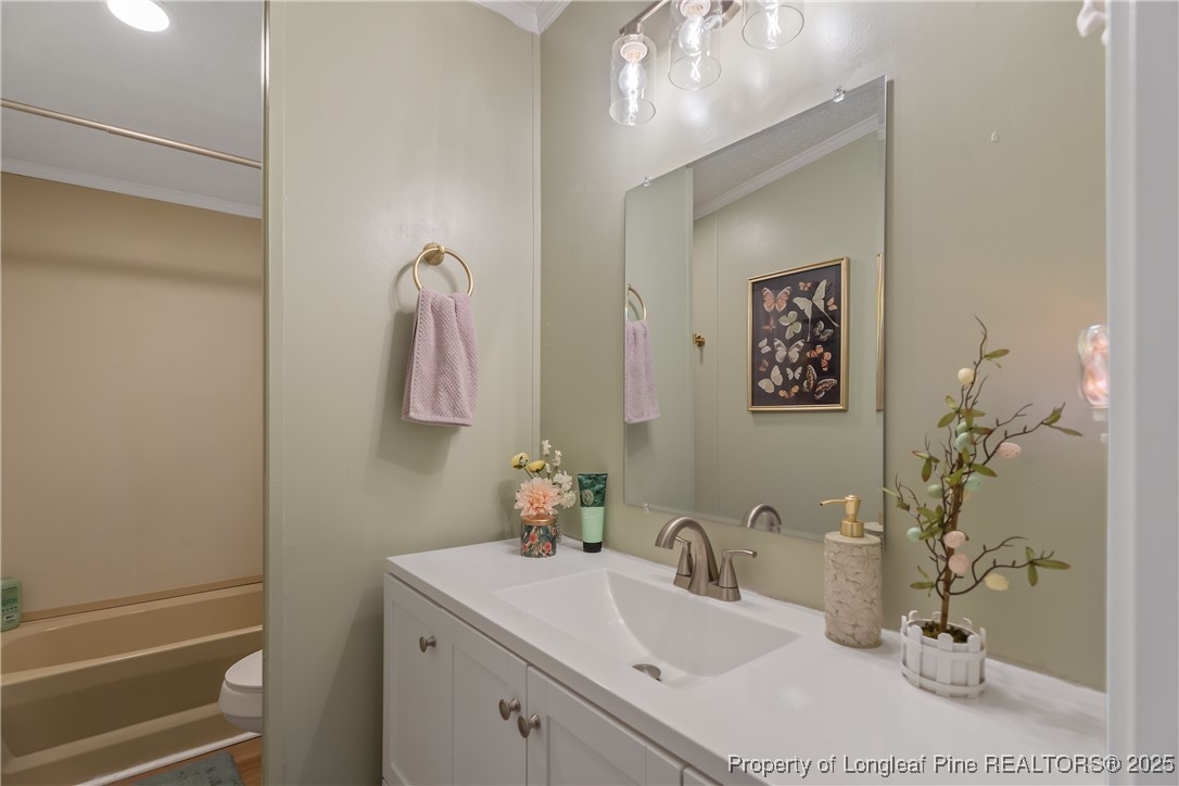 54 West Tryon Court Spring Lake, NC 28390 - Photo 33 of 43 a bathroom with a sink vanity and mirror