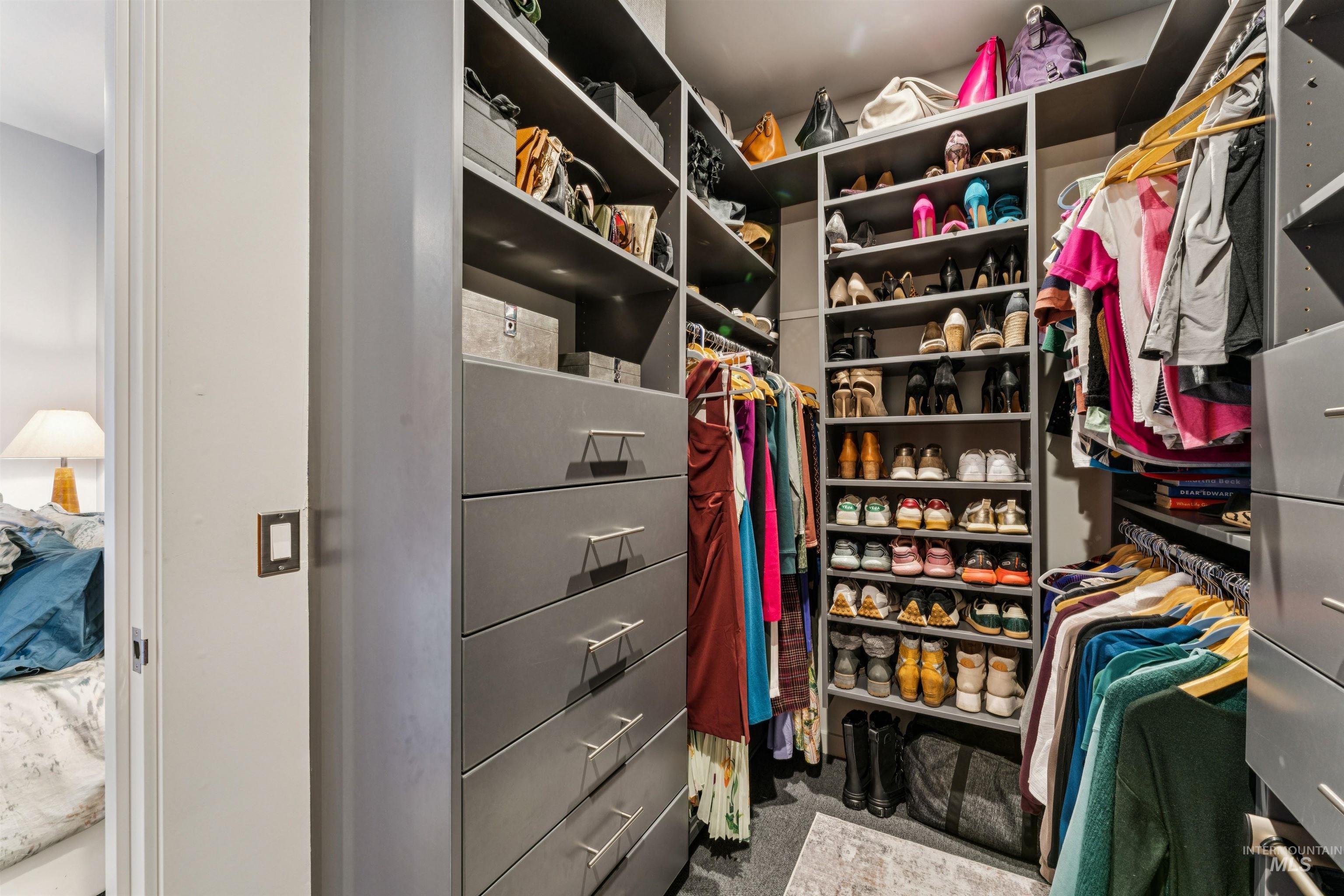 119 South 10th Street, Unit 307 Boise, ID 83702 - Photo 24 of 47 Custom closet system featuring built-in shelving, multiple hanging rods, and integrated drawer units with polished hardware