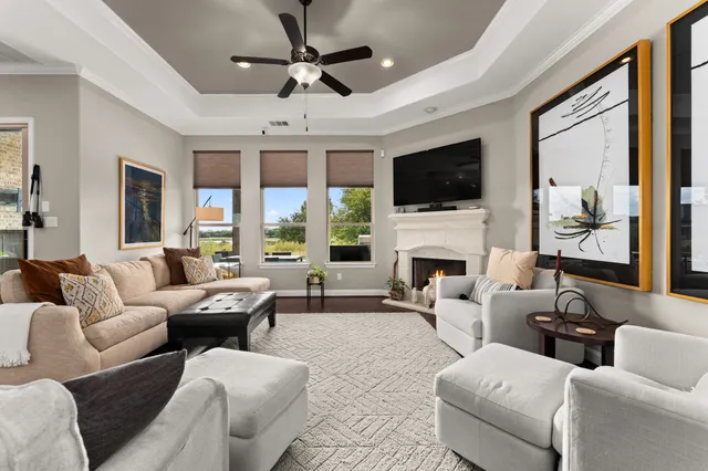 a living room with furniture a flat screen tv and a fireplace
