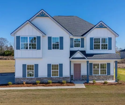 a front view of a residential houses with yard