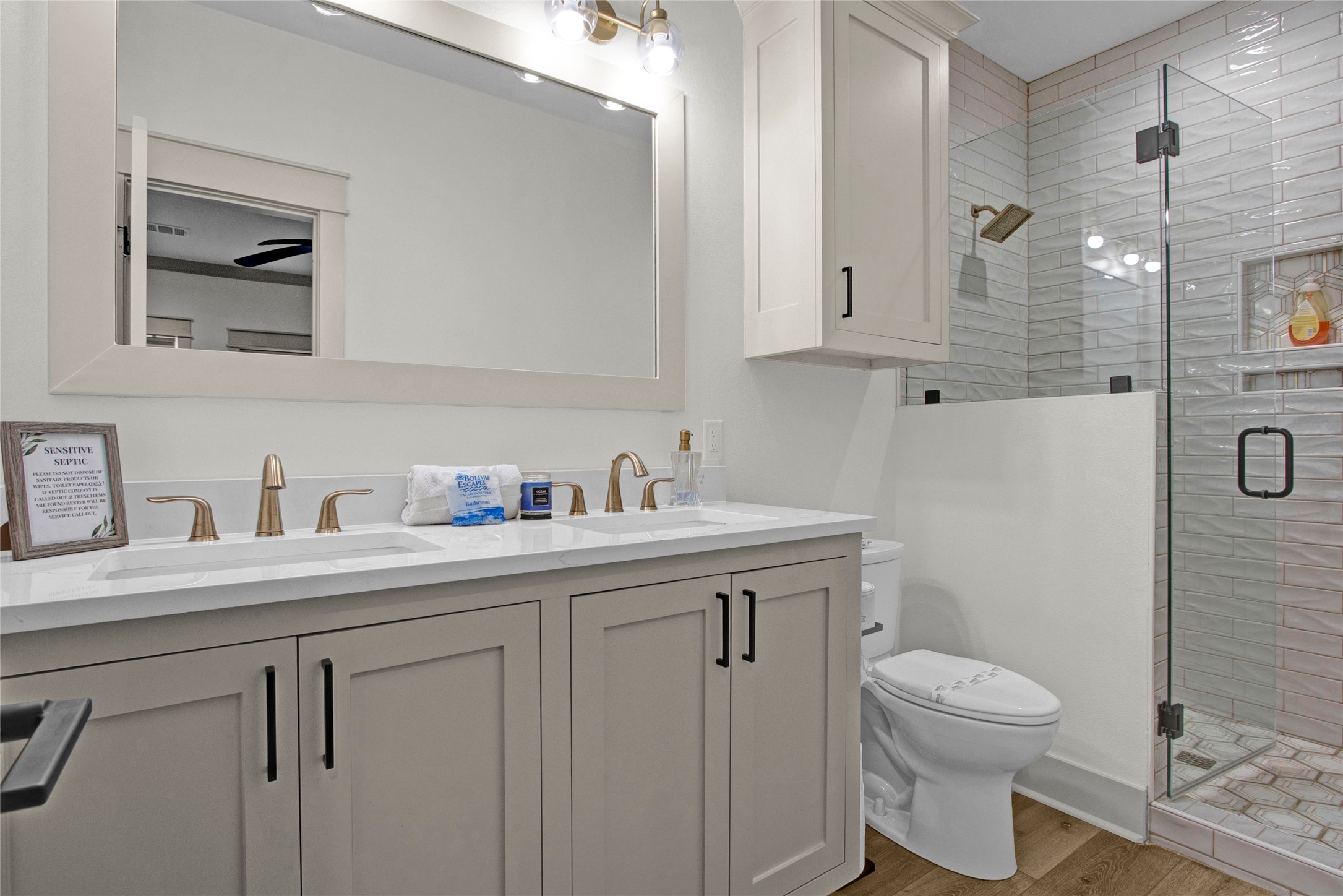 2906 Shady Lane Crystal Beach, TX 77650 - Photo 14 of 35 a bathroom with a toilet a sink a mirror and vanity