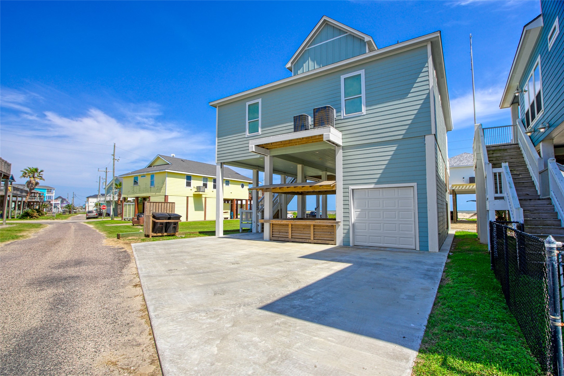 2906 Shady Lane Crystal Beach, TX 77650 - Photo 29 of 35 a view of a house with a yard and table and chairs under an umbrella