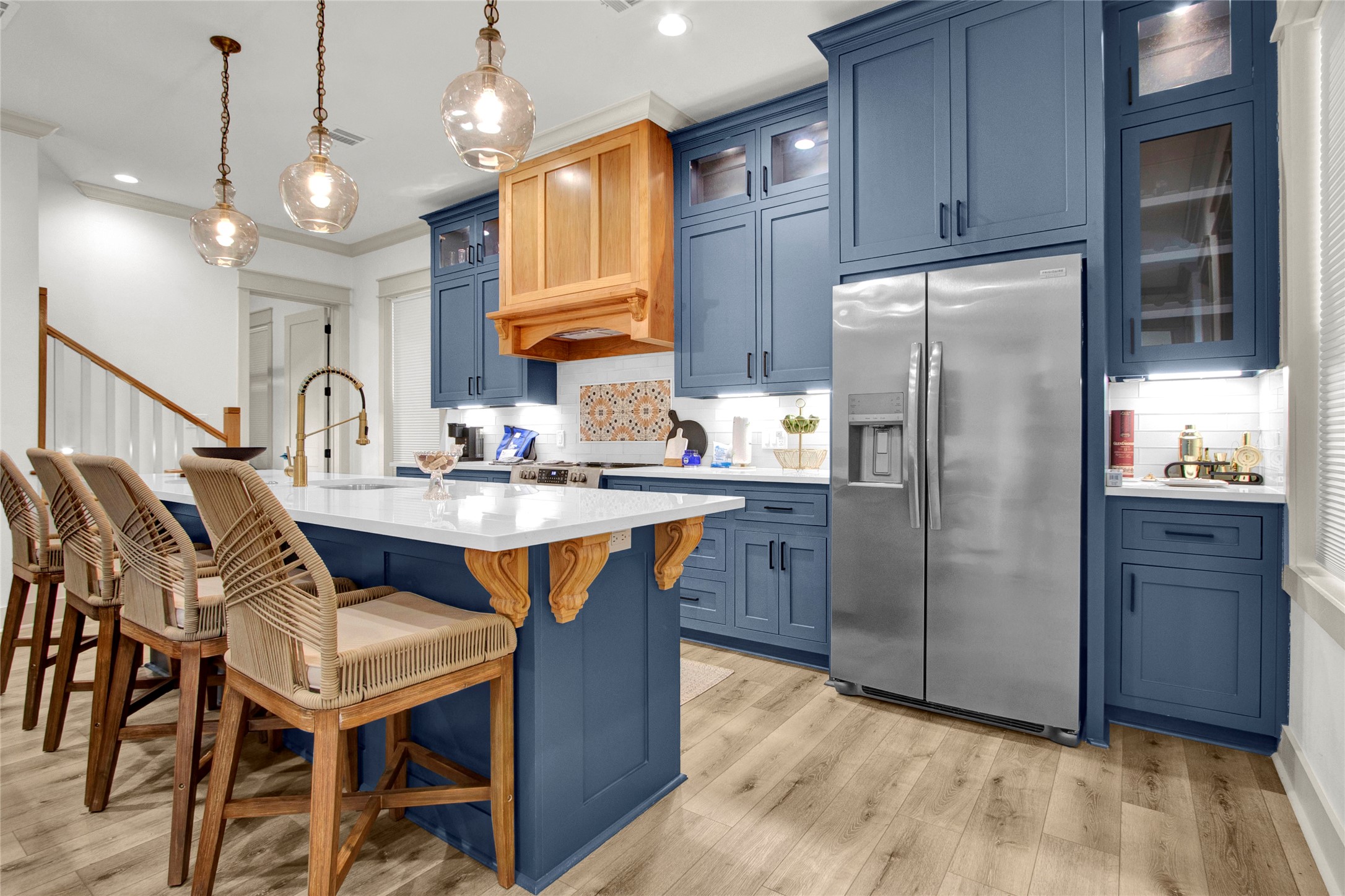 2906 Shady Lane Crystal Beach, TX 77650 - Photo 6 of 35 a kitchen with stainless steel appliances granite countertop a refrigerator a stove a sink dishwasher and a dining table with wooden floor