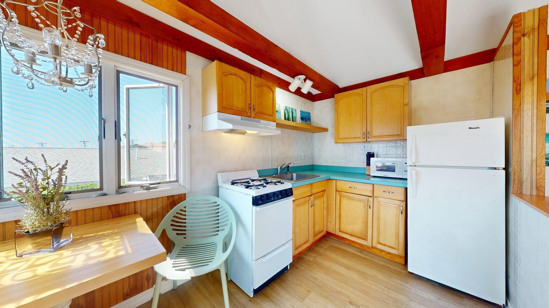 168 Shore Road, Unit 9 Truro, MA 02666 - Photo 15 of 33 a kitchen with stainless steel appliances granite countertop a refrigerator a stove and a wooden floor