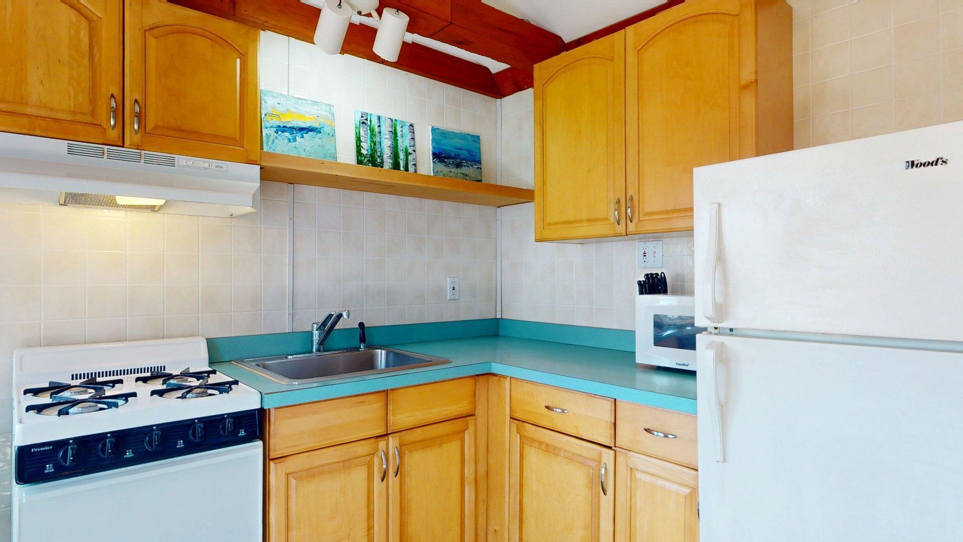 168 Shore Road, Unit 9 Truro, MA 02666 - Photo 17 of 33 a kitchen with stainless steel appliances granite countertop a refrigerator and a stove
