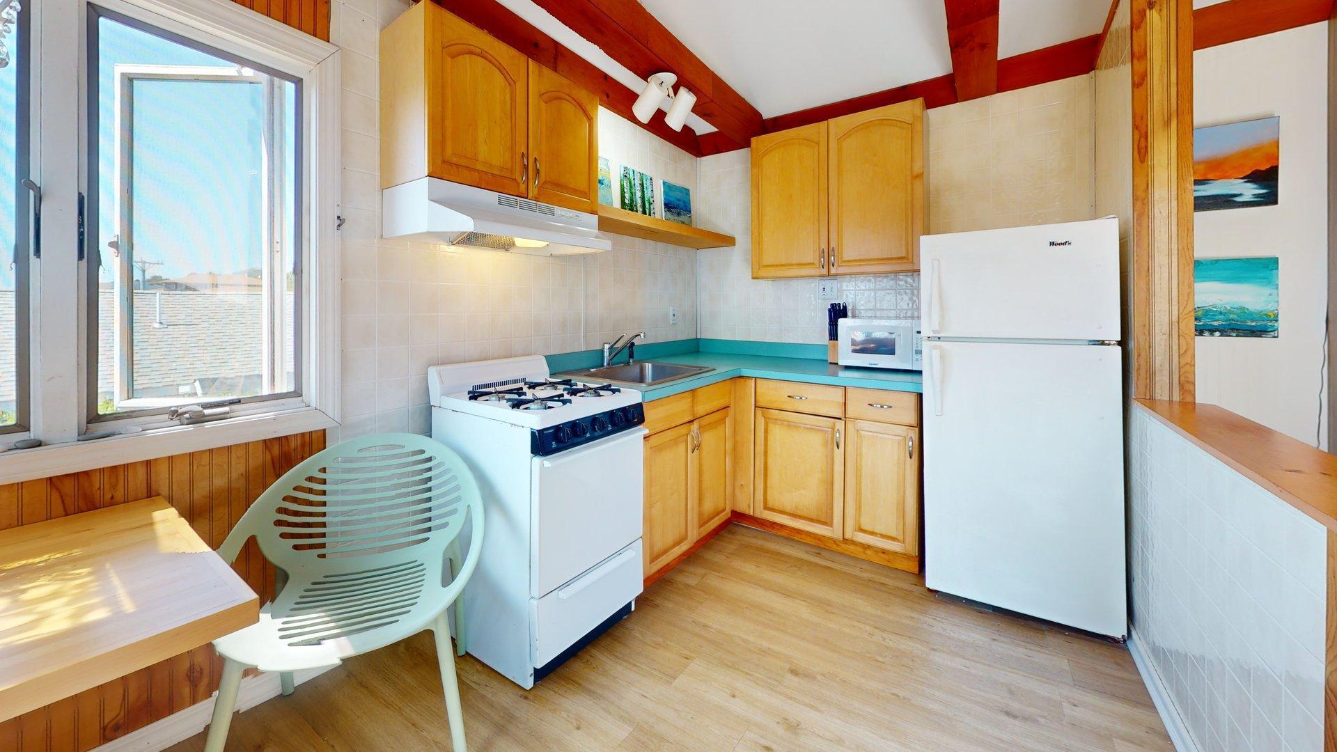 168 Shore Road, Unit 9 Truro, MA 02666 - Photo 20 of 33 a kitchen with a refrigerator a stove and wooden floor