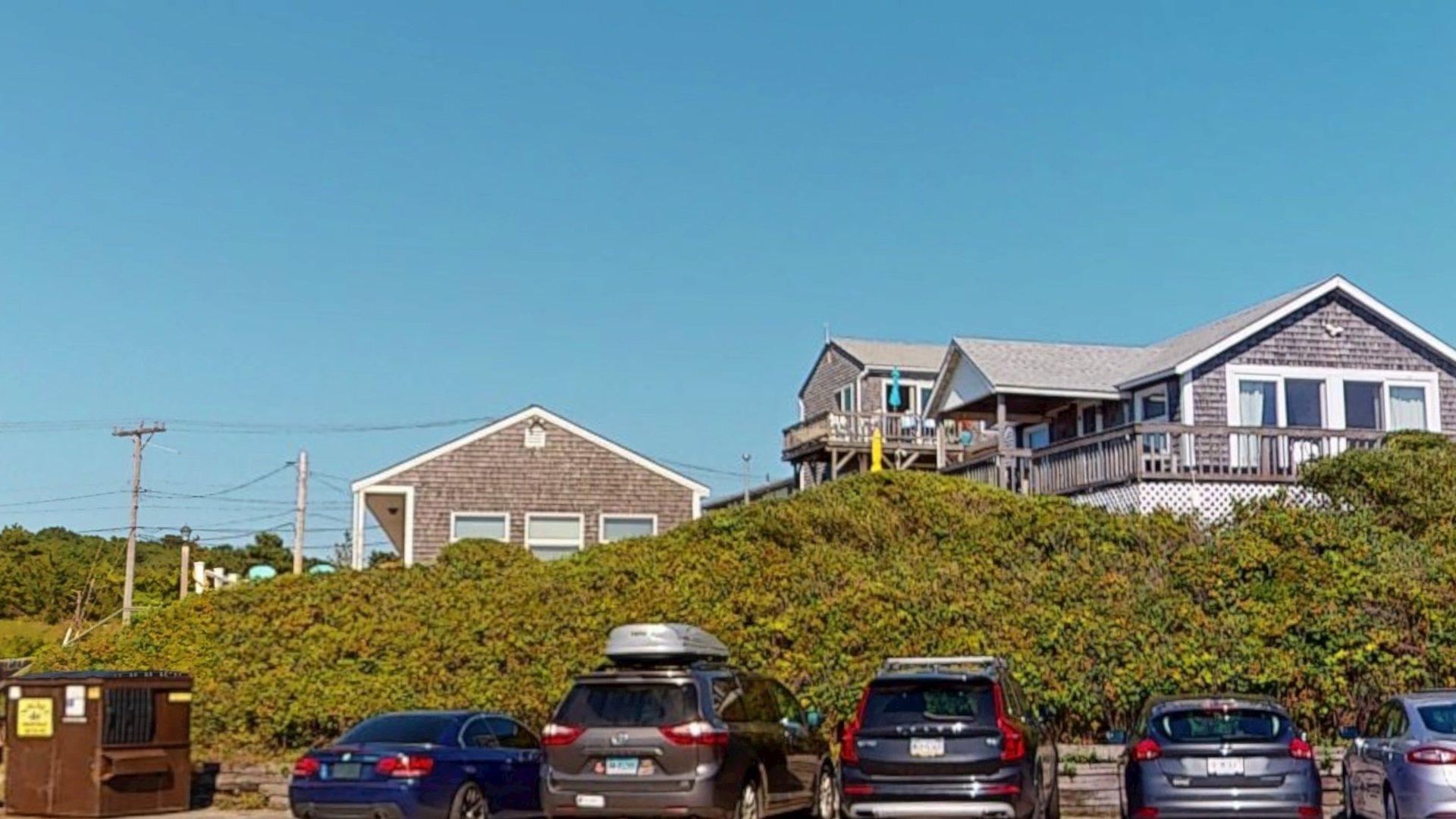 168 Shore Road, Unit 9 Truro, MA 02666 - Photo 27 of 33 a front view of a house with parking area