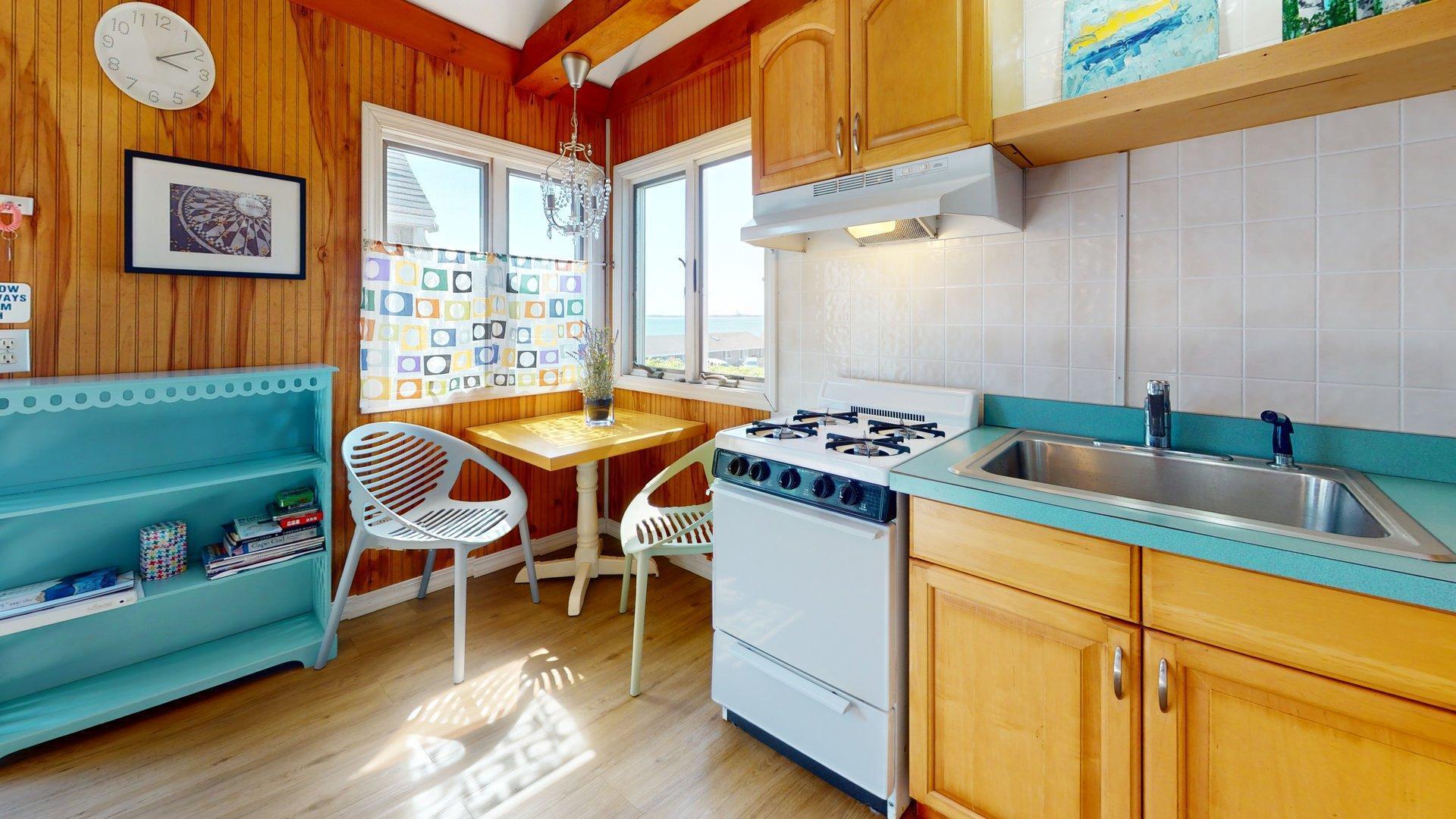 168 Shore Road, Unit 9 Truro, MA 02666 - Photo 7 of 33 a kitchen that has a table and chairs in it