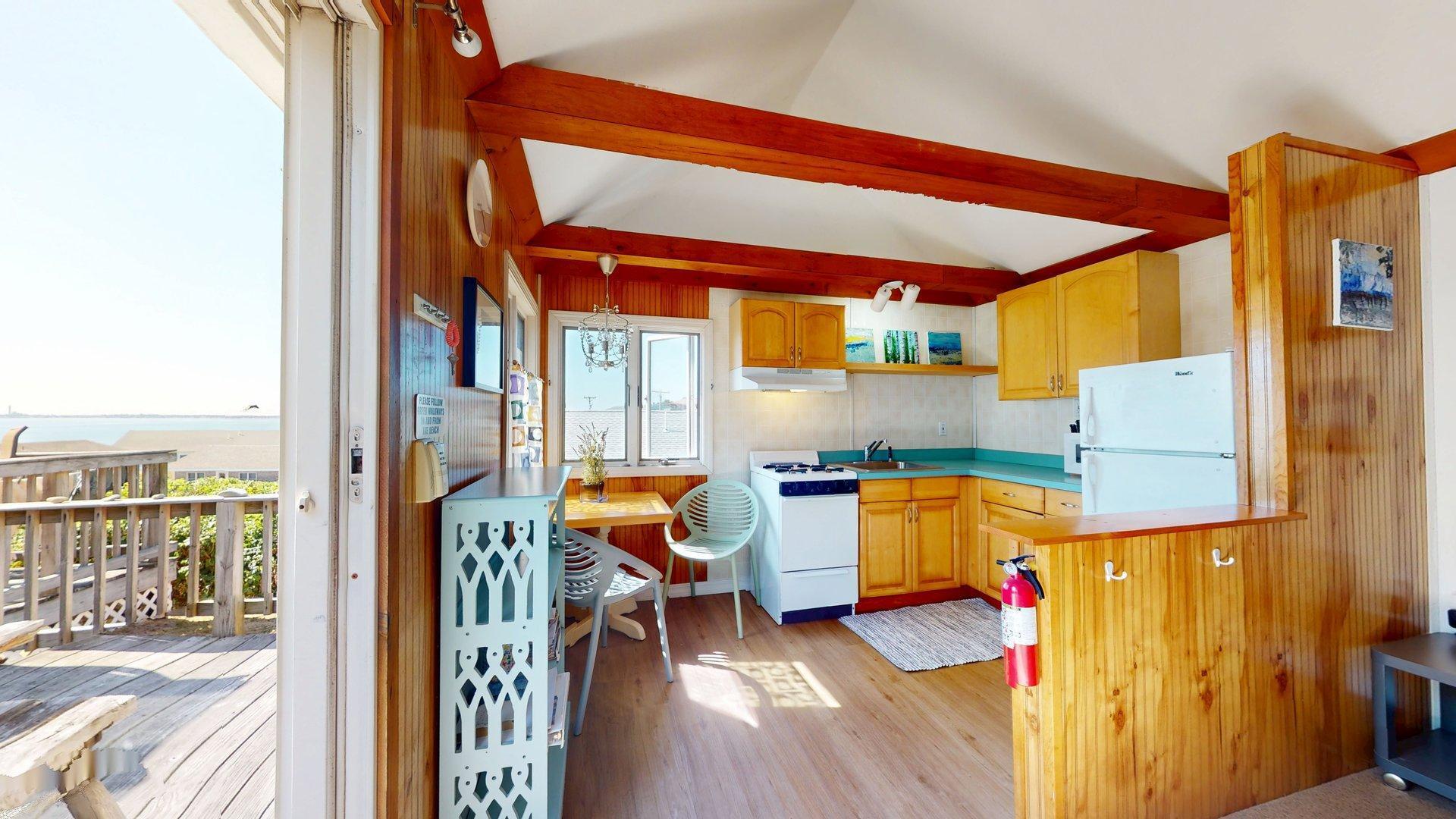 168 Shore Road, Unit 9 Truro, MA 02666 - Photo 8 of 33 a room with furniture and a wooden floor