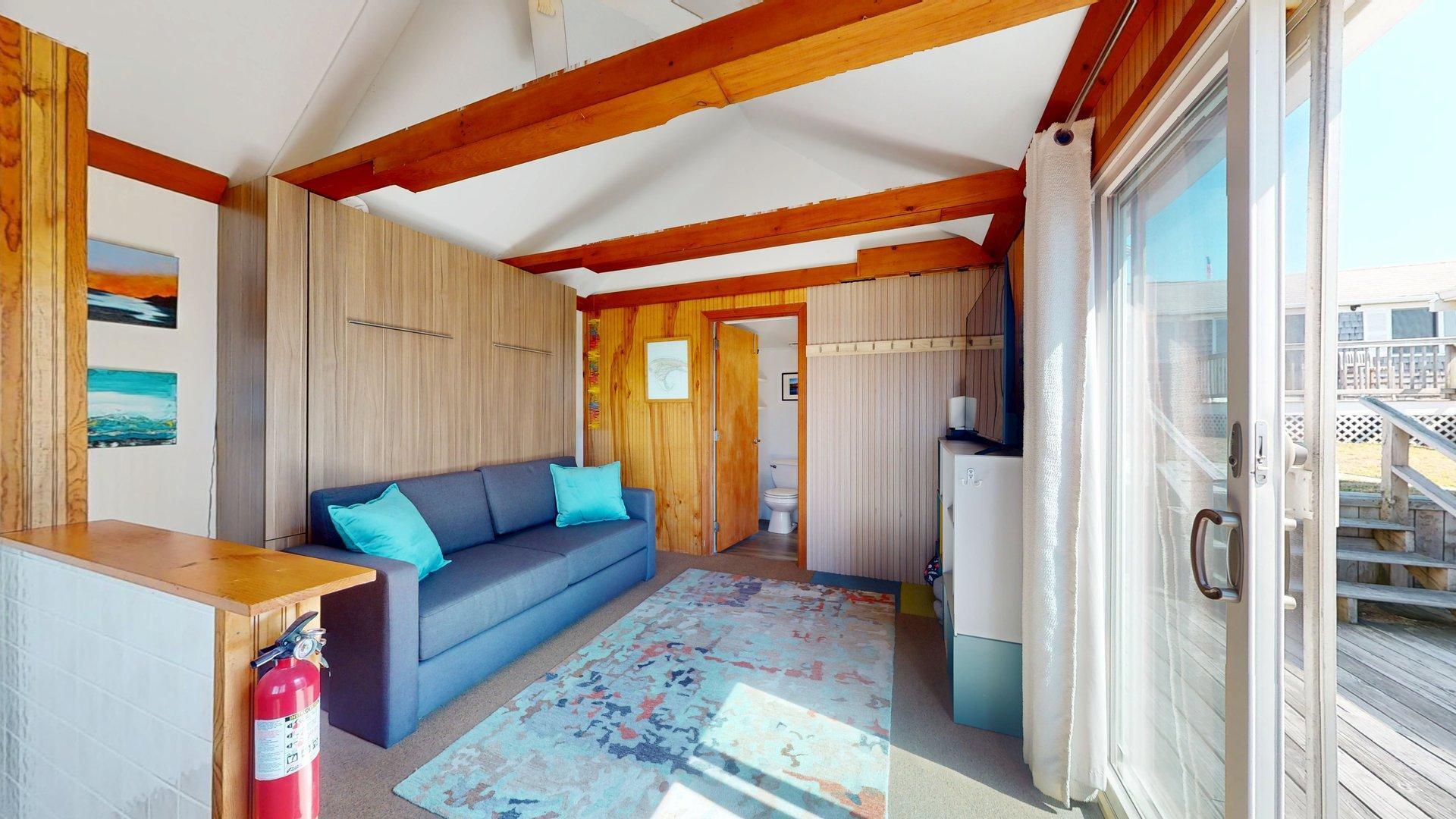 168 Shore Road, Unit 9 Truro, MA 02666 - Photo 9 of 33 a living room with furniture and a rug
