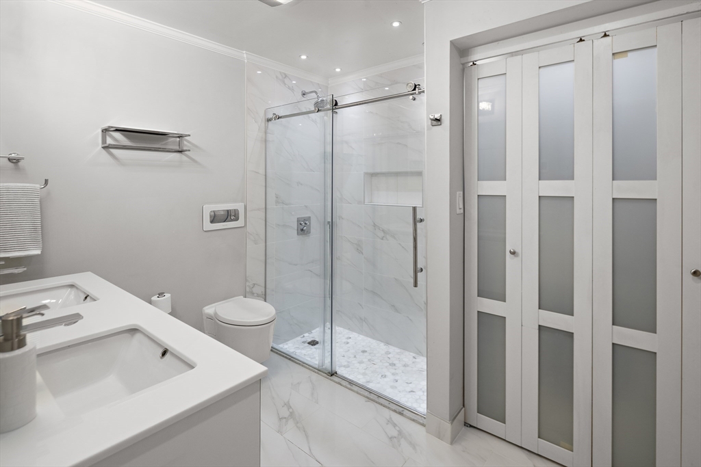 41 Warren Avenue, Unit 1 Boston, MA 02116 - Photo 11 of 20 a bathroom with a shower sink vanity and toilet