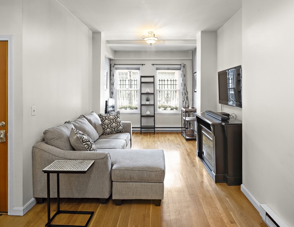 41 Warren Avenue, Unit 1 Boston, MA 02116 - Photo 3 of 20 a living room with furniture and a flat screen tv