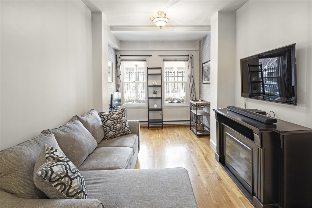 41 Warren Avenue, Unit 1 Boston, MA 02116 - Photo 4 of 20 a living room with furniture and a fireplace