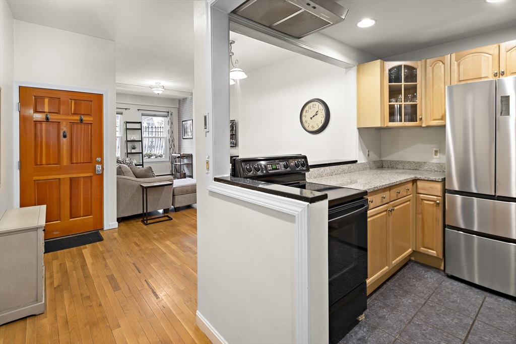 41 Warren Avenue, Unit 1 Boston, MA 02116 - Photo 8 of 20 a kitchen with stainless steel appliances granite countertop a refrigerator and a stove