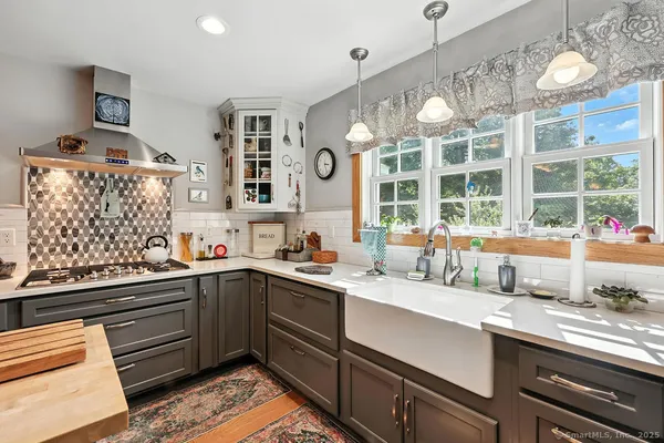 a kitchen with a sink window and cabinets