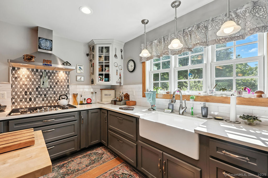 a kitchen with a sink window and cabinets