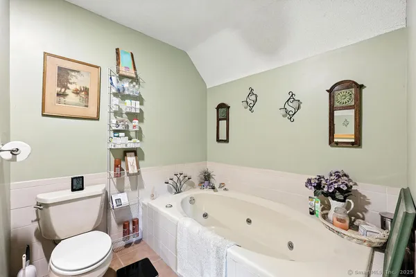 a white toilet sitting next to a bathroom sink and tub