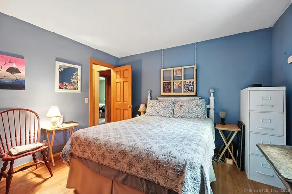 a bedroom with a bed a table and chair