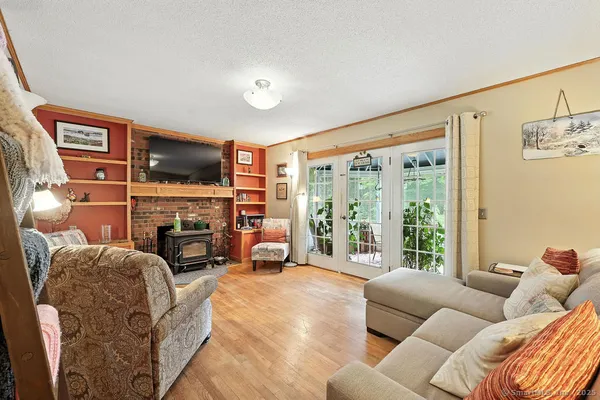 a living room with furniture a large window and a flat screen tv