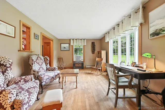 a living room with furniture and large windows