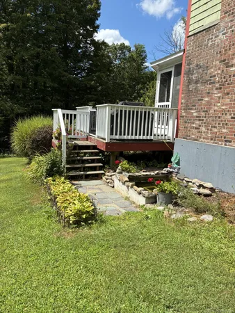 a view of a chair and table in the garden