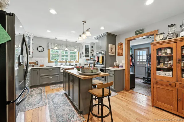 a kitchen with stainless steel appliances granite countertop counter space cabinets and wooden floor