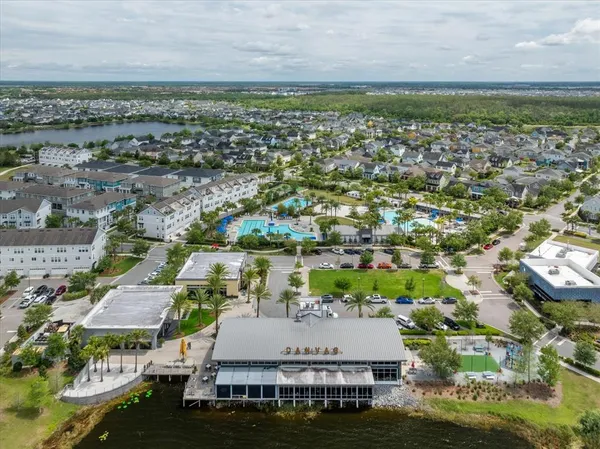 an aerial view of residential houses with outdoor space and river