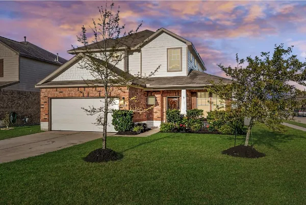 a front view of a house with a garden and plants