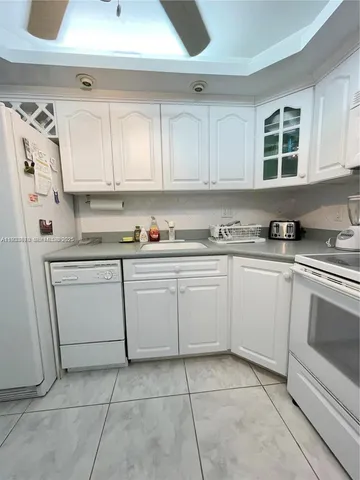 a kitchen with cabinets appliances and a sink