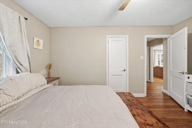 a bedroom with a bed and a mirror