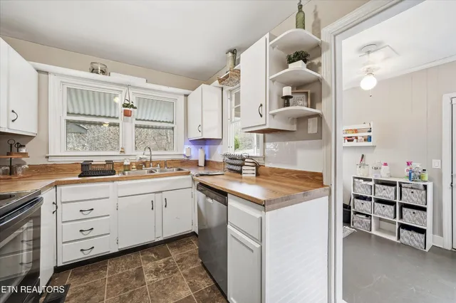 a kitchen with cabinets and window