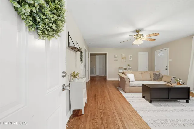 a living room with furniture and a chandelier