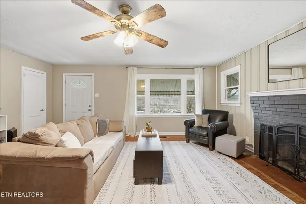 a living room with furniture and a fireplace