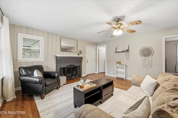 a living room with furniture a fireplace and a flat screen tv