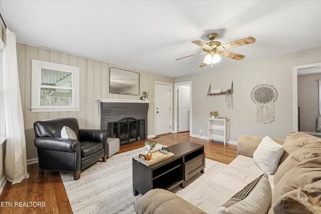 a living room with furniture a fireplace and a flat screen tv