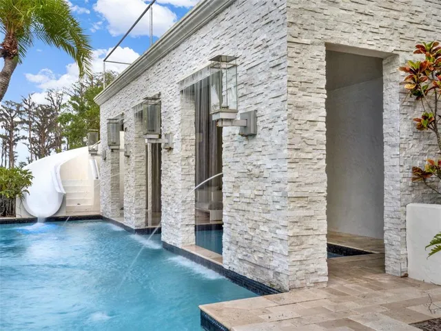 a view of an house with swimming pool and porch