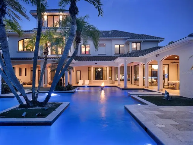 a view of a swimming pool with outdoor seating