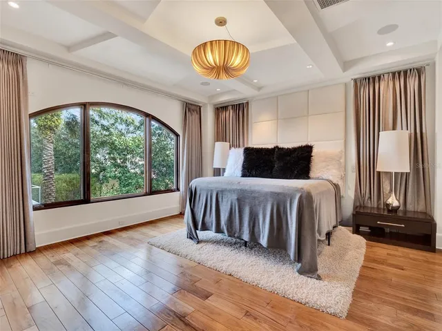 a view of a hallway with wooden floor and a cabinet