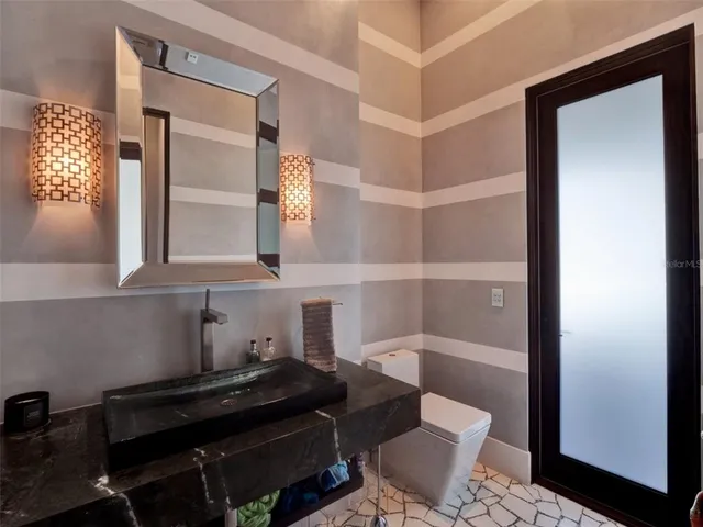 a bathroom with a bathtub shower sink mirror and toilet