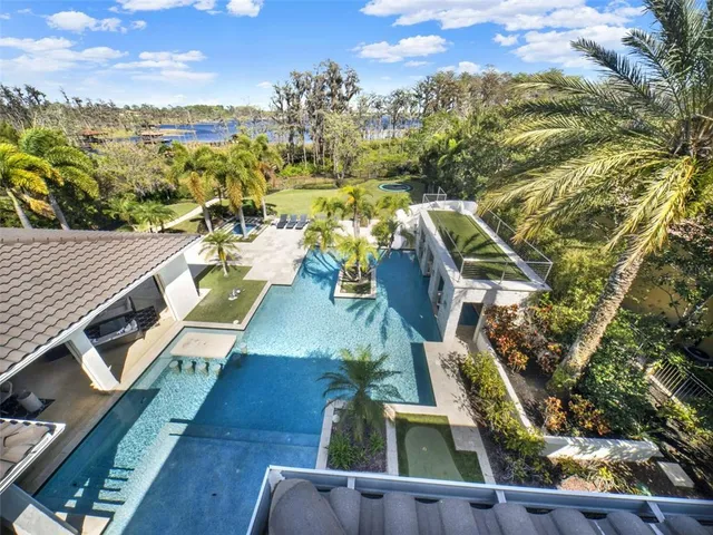 a view of a house with backyard and sitting area