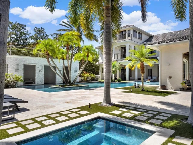 a view of a white house with a yard