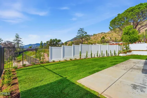 a view of a backyard with swimming pool