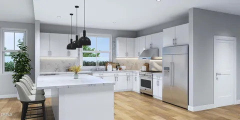 a kitchen with a white center island and cabinets