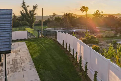 a view of a balcony with wooden fence and floor