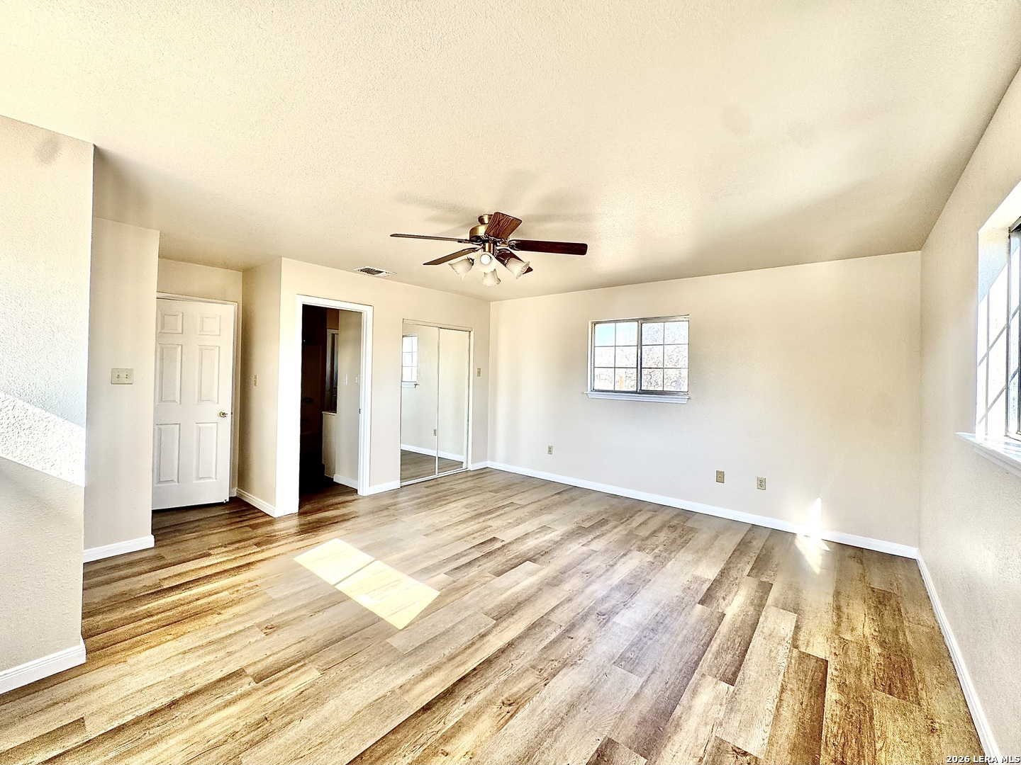 19524 South Benton Street Lytle, TX 78052 - Photo 12 of 22 a view of empty room with wooden floor and fan
