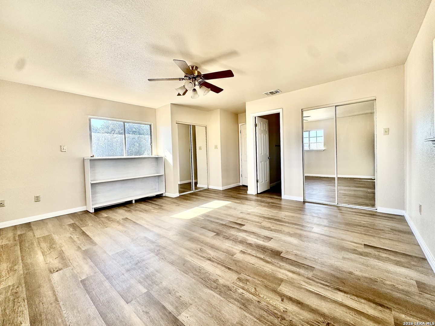 19524 South Benton Street Lytle, TX 78052 - Photo 13 of 22 a view of empty room with wooden floor and fan